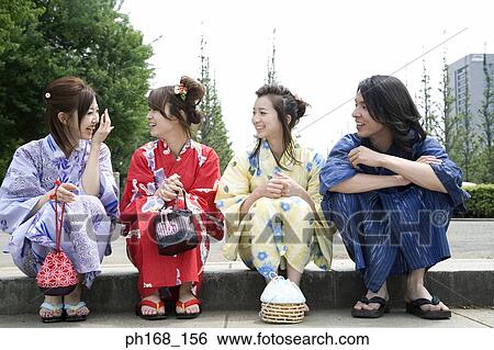 A small group of people sitting on the steps View Large Photo Image Stock Photograph - A small group of people sitting on the steps. Fotosearch