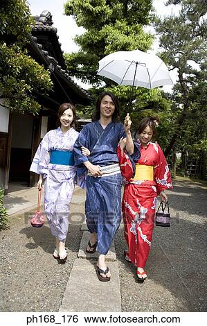 Stock Photograph - A small group of people taking a stroll. Fotosearch