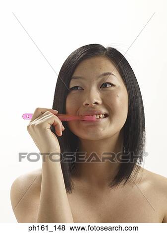 A woman brushing her teeth View Large Photo Image Stock Photo - A woman brushing her teeth. Fotosearch