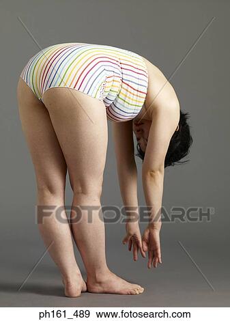 A woman in striped swimsuit, bending forward View Large Photo Image Stock Photo - A woman in striped swimsuit, bending forward. Fotosearch