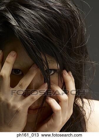 A young woman covering her face with her hands View Large Photo Image Stock Image - A young woman covering her face with her hands. Fotosearch