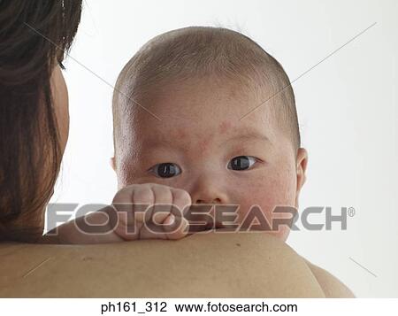 Baby looking over the shoulder of woman, close-up View Large Photo Image Stock Image - Baby looking over the shoulder of woman, close-up. Fotosearch