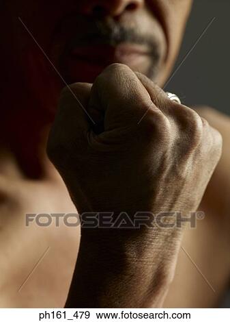 Bare-chested man raising his fist View Large Photo Image Stock Photo - Bare-chested man raising his fist. Fotosearch