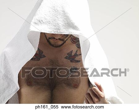Stock Photography - Bare chested man with a white towel covering his head. Fotosearch