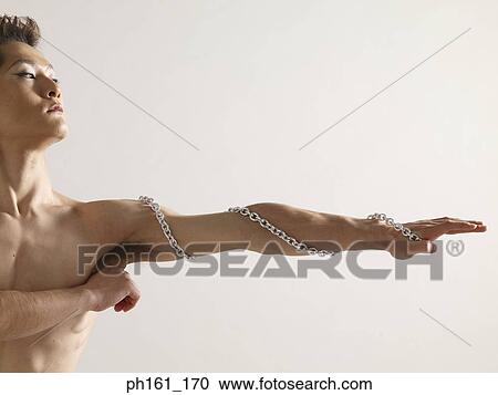 Bare-chested man with metal chain around his arm View Large Photo Image Stock Image - Bare-chested man with metal chain around his arm. Fotosearch