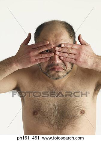 Bare chested mature man, peering through his fingers, close-up View Large Photo Image Stock Image - Bare chested mature man, peering through his fingers, close-up. Fotosearch