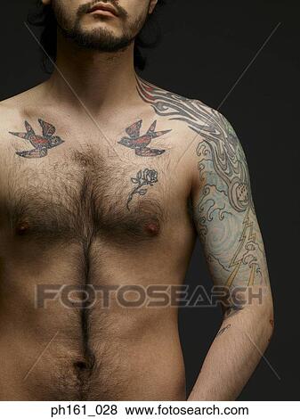 Stock Photo - Bare chested young man, standing. Fotosearch