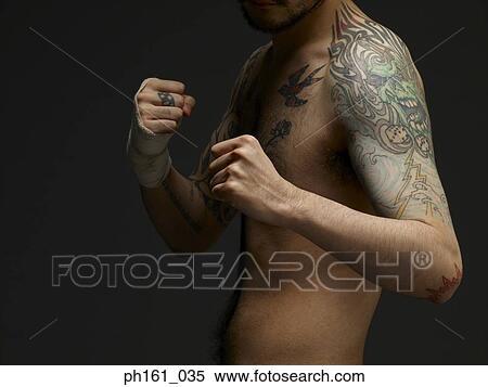 Bare chested young man with tattoos, ready to box View Large Photo Image Stock Photography - Bare chested young man with tattoos, ready to box. Fotosearch