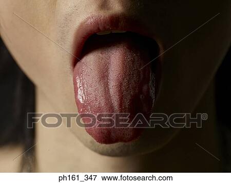 Close-up of a man sticking out his tongue View Large Photo Image Stock Photo - Close-up of a man sticking out his tongue. Fotosearch