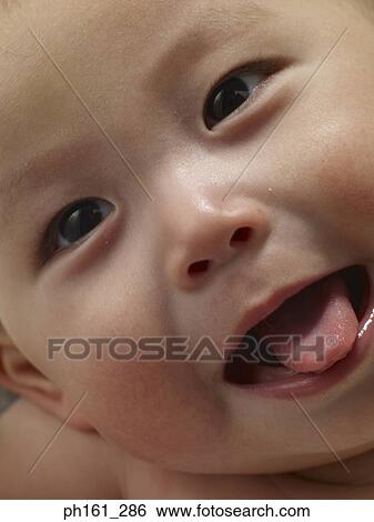 Close-up of baby making a face View Large Photo Image Stock Photograph - Close-up of baby making a face. Fotosearch