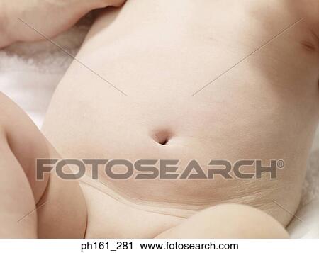 Stock Image - Close-up of baby's belly. Fotosearch