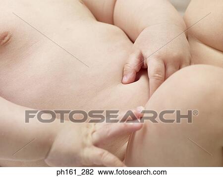 Close-up of baby's hand on torso View Large Photo Image Stock Image - Close-up of baby's hand on torso. Fotosearch