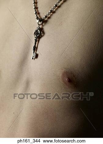 Picture - Close-up of bare chested young man with his necklace. Fotosearch