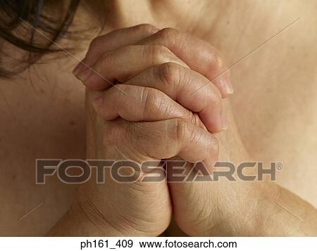 Close-up of hands clasped together View Large Photo Image Stock Photo - Close-up of hands clasped together. Fotosearch