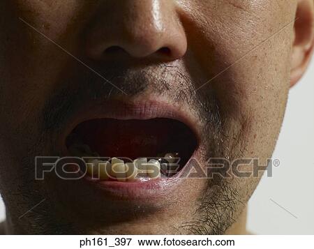 Close-up of man with mouth open View Large Photo Image Stock Photo - Close-up of man with mouth open. Fotosearch