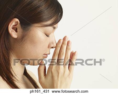 Close-up of woman with hands clasped together, eyes closed View Large Photo Image Stock Image - Close-up of woman with hands clasped together, eyes closed. Fotosearch