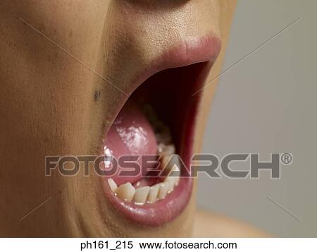 Close-up of young man with mouth open wide View Large Photo Image Stock Photography - Close-up of young man with mouth open wide. Fotosearch