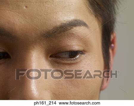 Picture - Close-up of young man's eyes, looking sideways. Fotosearch