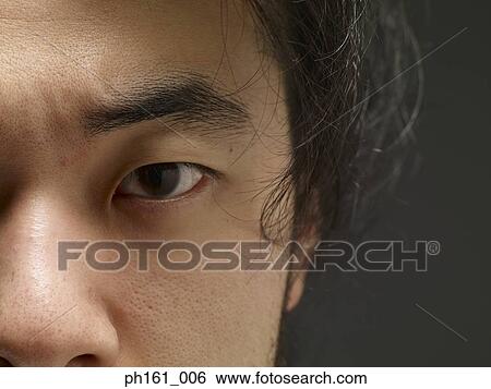 Stock Photograph - Close-up on the eye of a young man. Fotosearch