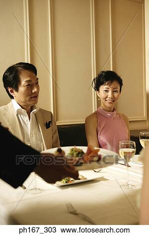 Couple being served food by a waiter View Large Photo Image Stock Image - Couple being served food by a waiter. Fotosearch