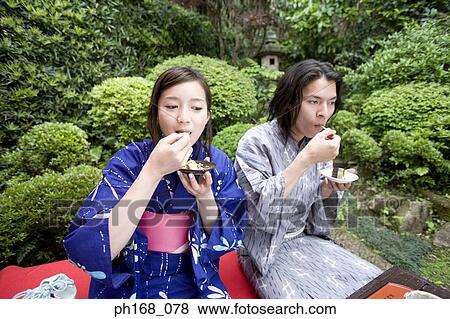 Stock Photo - Couple enjoying a meal outdoors. Fotosearch