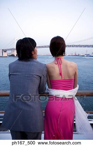 Couple enjoying the sea view from cruise ship, rear view View Large Photo Image Stock Image - Couple enjoying the sea view from cruise ship, rear view. Fotosearch