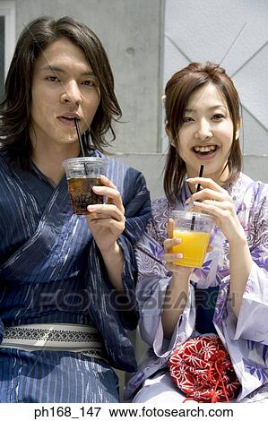 Stock Photo - Couple holding a drink each. Fotosearch