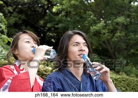 Couple in traditional Japanese clothing drinking water View Large Photo Image Picture - Couple in traditional Japanese clothing drinking water. Fotosearch