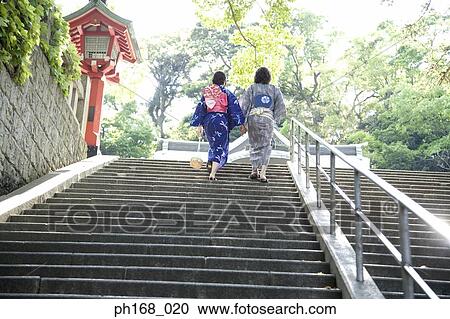 Couple in traditional Japanese clothing walking up the steps, rear view View Large Photo Image Stock Image - Couple in traditional Japanese clothing walking up the steps, rear view. Fotosearch