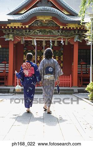 Couple in traditional Japanese clothing walking to temple, rear view View Large Photo Image Stock Image - Couple in traditional Japanese clothing walking to temple, rear view. Fotosearch