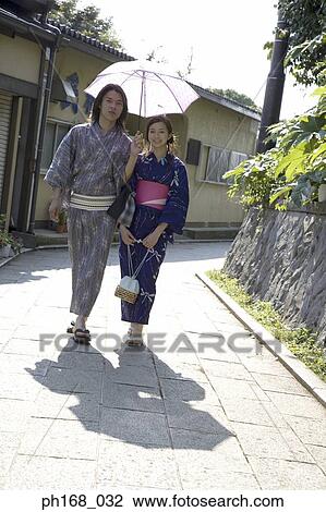 Couple in traditional Japanese clothing taking a stroll View Large Photo Image Stock Image - Couple in traditional Japanese clothing taking a stroll . Fotosearch