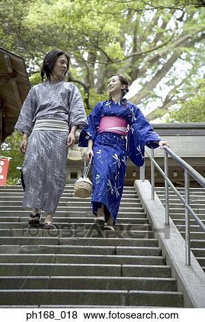 Stock Photo - Couple in traditional Japanese clothing walking down steps. Fotosearch