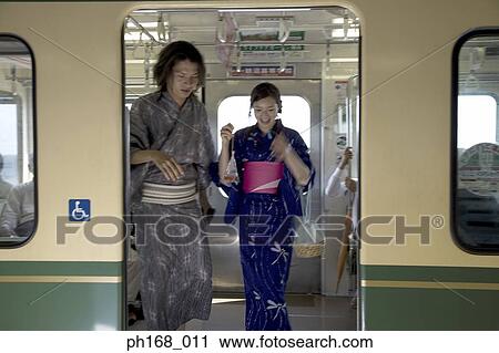 Couple in traditional Japanese clothing, getting off train View Large Photo Image Stock Image - Couple in traditional Japanese clothing, getting off train. Fotosearch