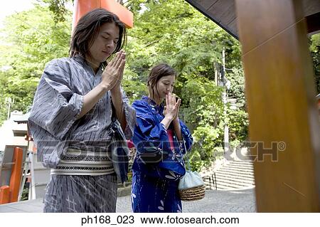 Couple in traditional Japanese clothing, praying View Large Photo Image Stock Image - Couple in traditional Japanese clothing, praying. Fotosearch