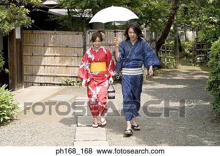 Stock Photo - Couple in traditional Japanese clothing, walking. Fotosearch