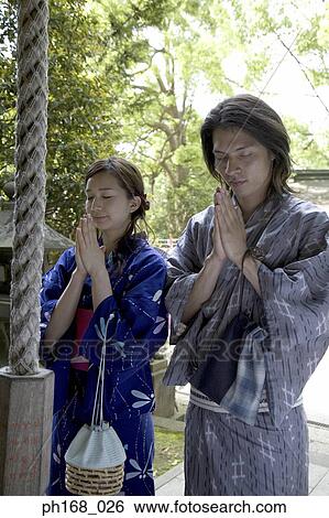 Couple in traditional Japanese clothing, praying View Large Photo Image Stock Photograph - Couple in traditional Japanese clothing, praying. Fotosearch