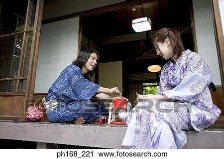 Stock Image - Couple making dessert by corridor. Fotosearch