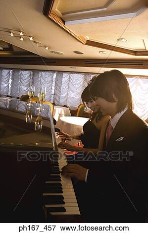 Couple playing piano together View Large Photo Image Stock Photo - Couple playing piano together. Fotosearch
