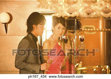 Picture - Couple relaxing by bar in cruise ship. Fotosearch