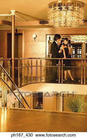 Couple relaxing by bar in cruise ship View Large Photo Image Stock Image - Couple relaxing by bar in cruise ship. Fotosearch