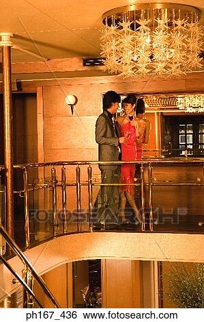 Stock Photograph - Couple relaxing by bar in cruise ship. Fotosearch
