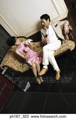 Couple relaxing on a chaise lounge View Large Photo Image Stock Image - Couple relaxing on a chaise lounge. Fotosearch