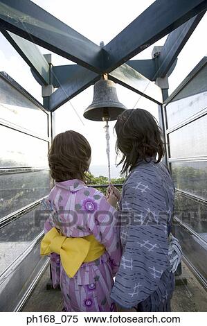 Couple ringing a bell, rear view View Large Photo Image Stock Photography - Couple ringing a bell, rear view. Fotosearch