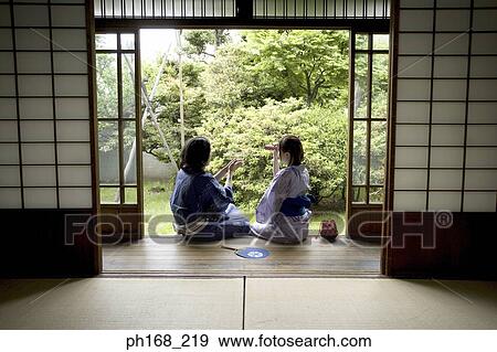Couple sitting by corridor, rear view View Large Photo Image Stock Photo - Couple sitting by corridor, rear view. Fotosearch
