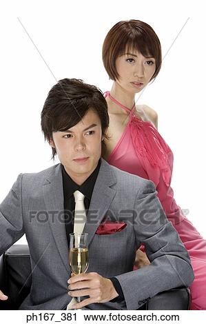 Stock Image - Couple sitting on a sofa. Fotosearch