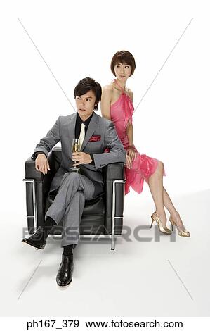 Stock Photo - Couple sitting on a sofa. Fotosearch