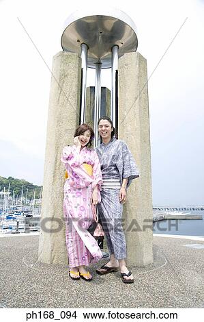 Picture - Couple standing in front of a structure. Fotosearch