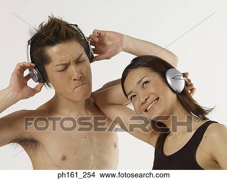 Couple with headphones, dancing View Large Photo Image Picture - Couple with headphones, dancing. Fotosearch