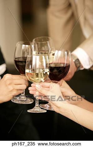 Stock Photography - Four people toasting with wine. Fotosearch