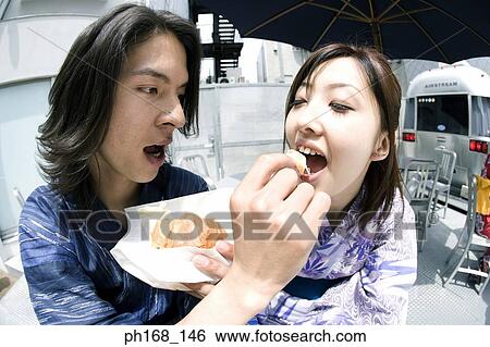 Man feeding woman with food View Large Photo Image Stock Photograph - Man feeding woman with food. Fotosearch
